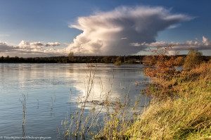 Impressive cloud formations reflected on the river IJssel